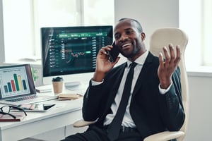 Competitive selling - sales man at a computer talking on the phone
